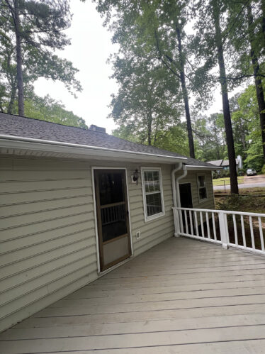 Gutter with LeafGuard system installed on house, preventing clogs and debris buildup.