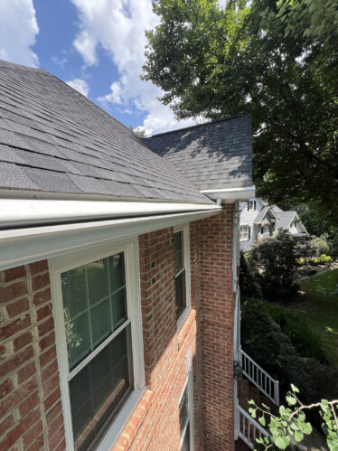 High-quality gutter system installed on brick home, ensuring clog-free, efficient rainwater management.