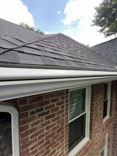 Gutter and roof detail of brick home with seamless gutters and slate roofing in Cincinnati, Kentucky.