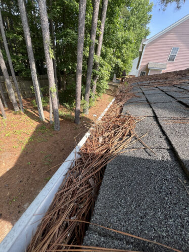 Gutter guards on a house prevent leaves and pine needles from clogging the gutters.
