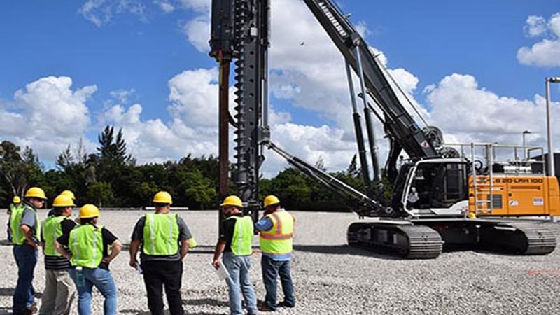 Engineers working on the construction site of the pile driver.