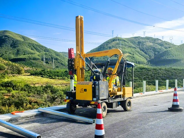 Pile driver driving piles on highway