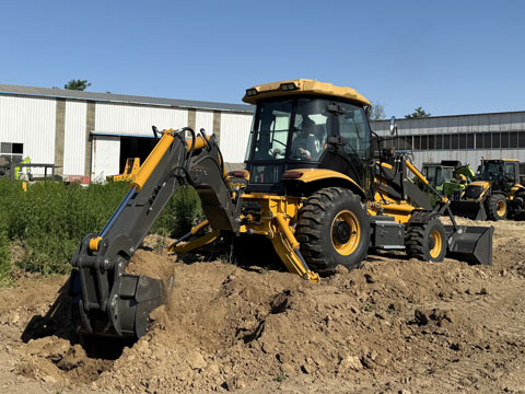 A backhoe is using its bucket to dig.