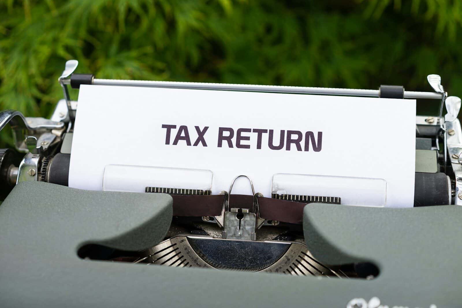 Typewriter with tax return document for tax filing and IRS submission.