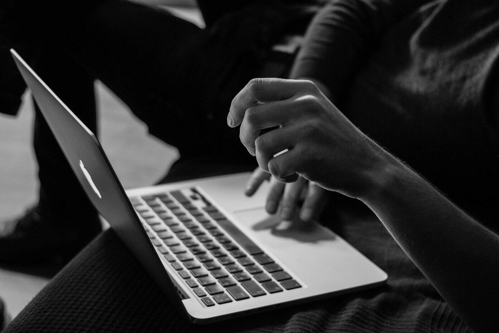 Person using a laptop for virtual tax prep and financial planning.
