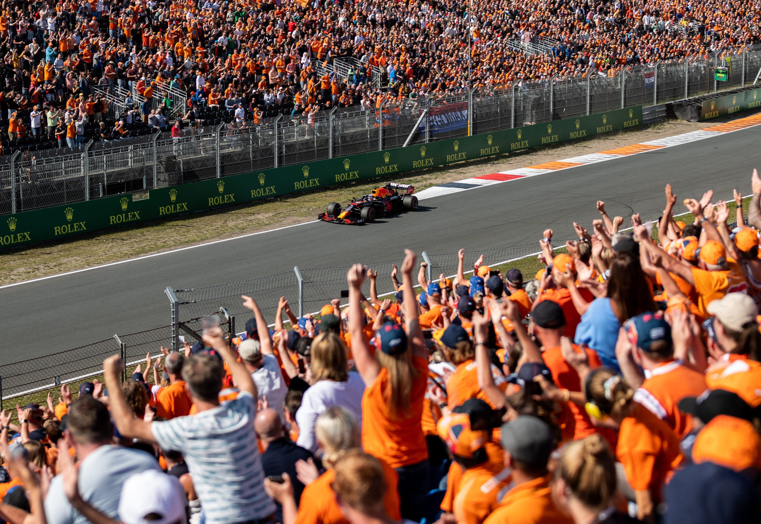 ZANDVOORT, NETHERLANDS - SEPTEMBER 04: Fans celebrate Max Verstappen of the Netherlands driving the (33) Red Bull Racing RB16B Honda during qualifying ahead of the F1 Grand Prix of The Netherlands at Circuit Zandvoort on September 04, 2021 in Zandvoort, Netherlands. (Photo by Boris Streubel/Getty Images) // Getty Images / Red Bull Content Pool // SI202109040791 // Usage for editorial use only //