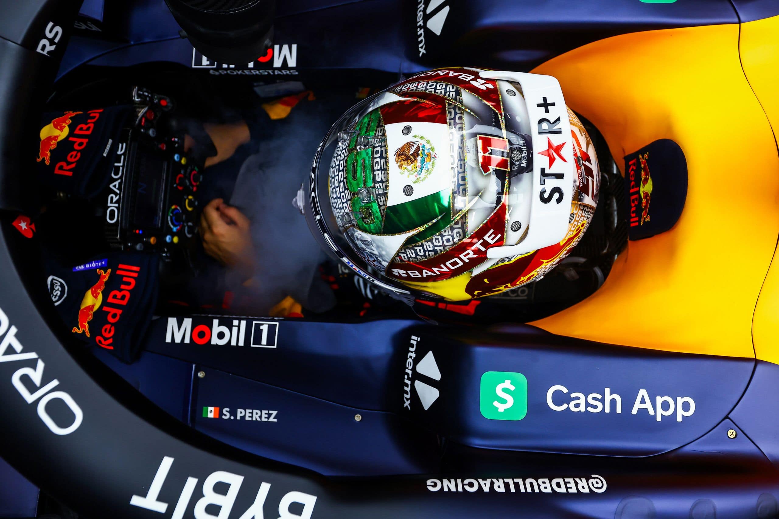 SINGAPORE, SINGAPORE - SEPTEMBER 16: Sergio Perez of Mexico and Oracle Red Bull Racing prepares to drive in the garage during qualifying ahead of the F1 Grand Prix of Singapore at Marina Bay Street Circuit on September 16, 2023 in Singapore, Singapore. (Photo by Mark Thompson/Getty Images) // Getty Images / Red Bull Content Pool // SI202309160396 // Usage for editorial use only //