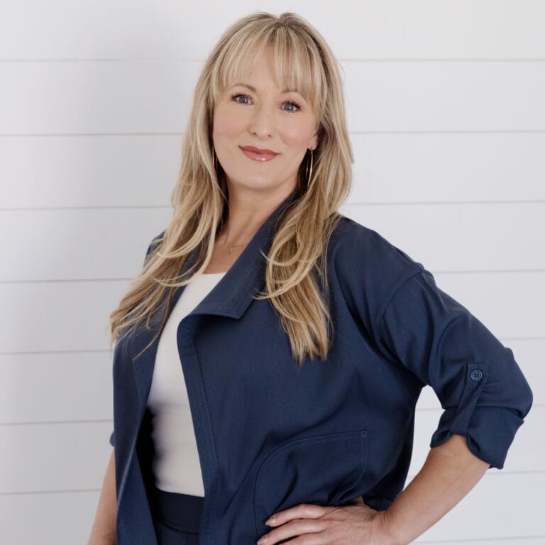 Faith Harmer, real estate agent, smiling confidently in a navy blazer.