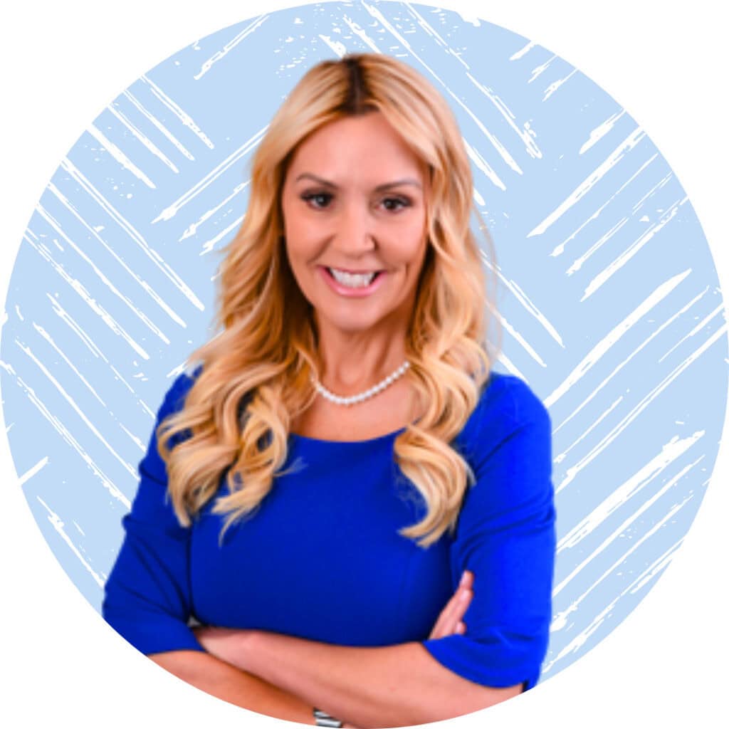 A portrait of Julie, a professional woman with blonde hair, wearing a blue top and pearl necklace, smiling against a light blue background.