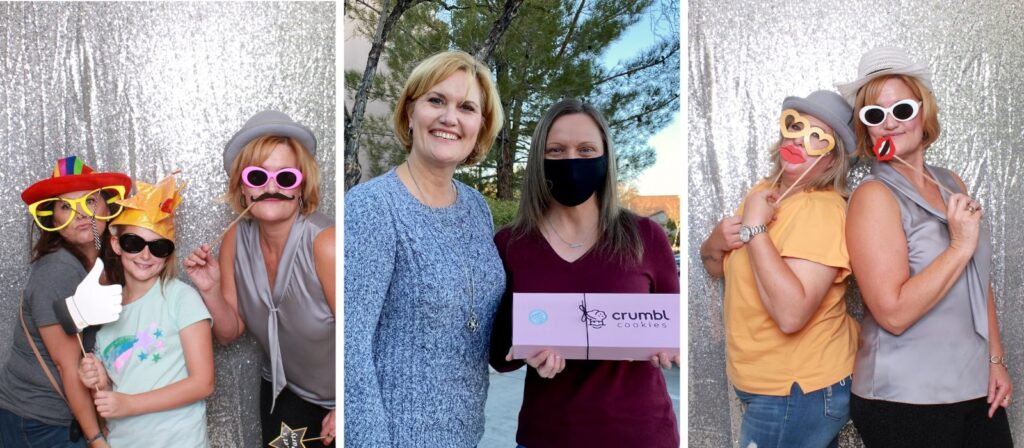 Faith Harmer with team member at a real estate event, smiling and wearing fun accessories.