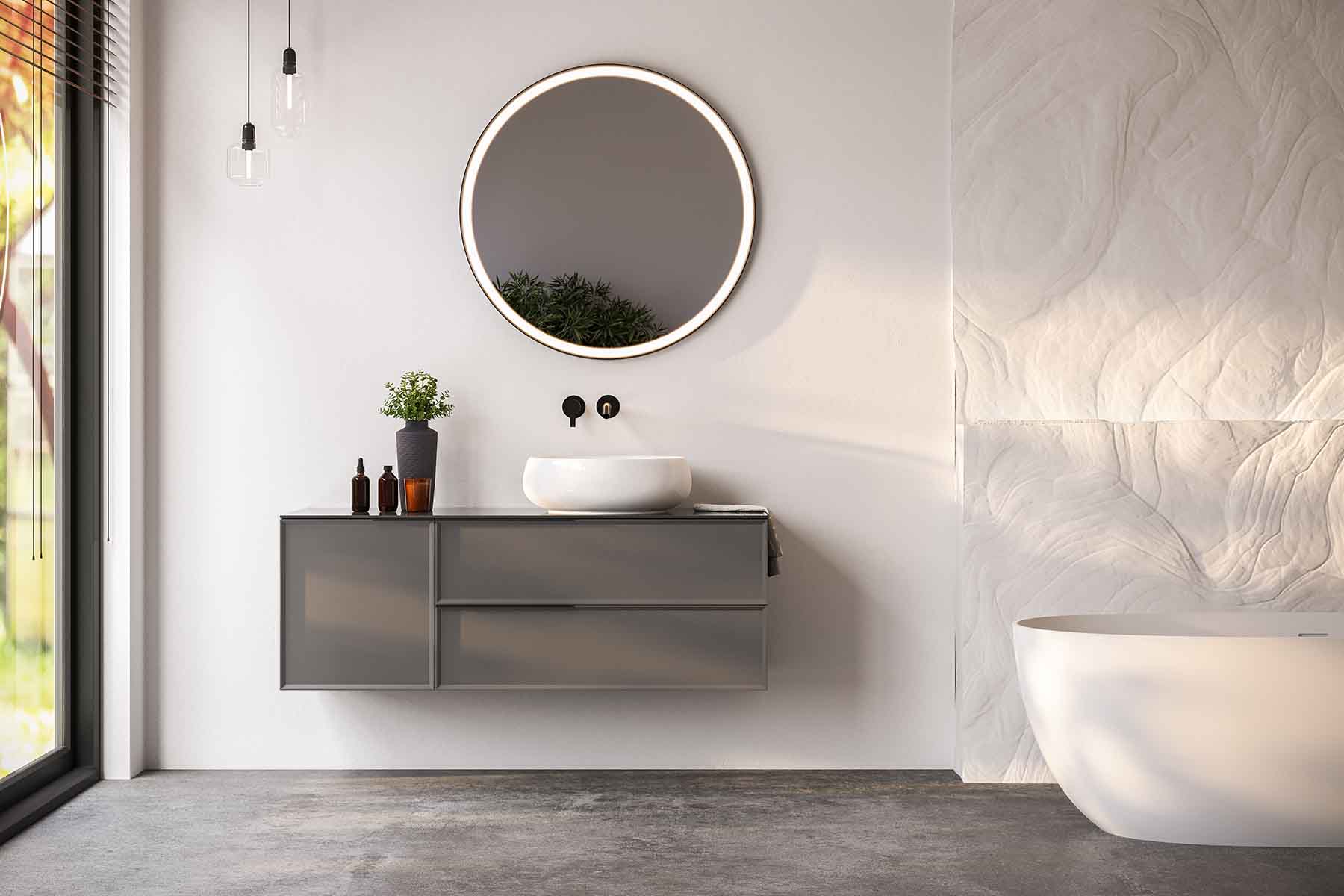 Modern bathroom vanity with round mirror, vessel sink, and sleek grey cabinetry for stylish bathroom.