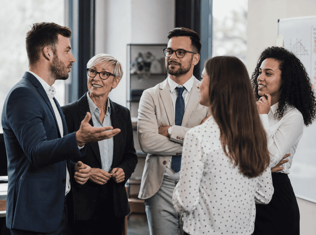 Small team discussing referral rate and customer advocacy results in an office setting