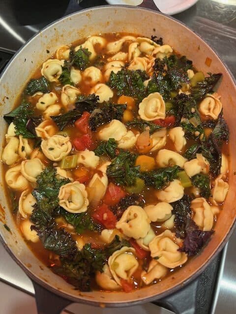 Picture of a Dutch oven filled with Tortellini Vegetable Soup.