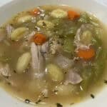 Picture of a bowl of chicken gnocchi noodle soup.