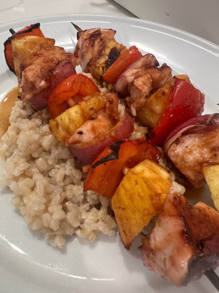 Pineapple Chicken Kabobs on a bed of brown rice.