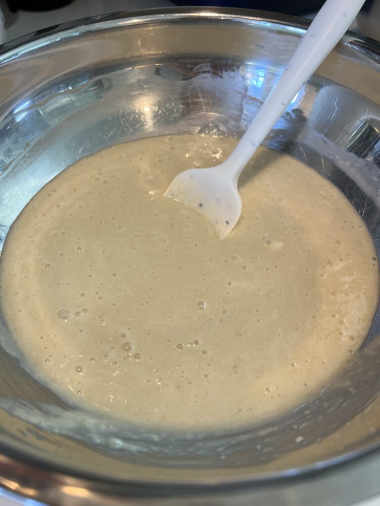 Picture of Baked Apple Cinnamon Doughnut Holes batter in a stainless steel mixing bowl. 