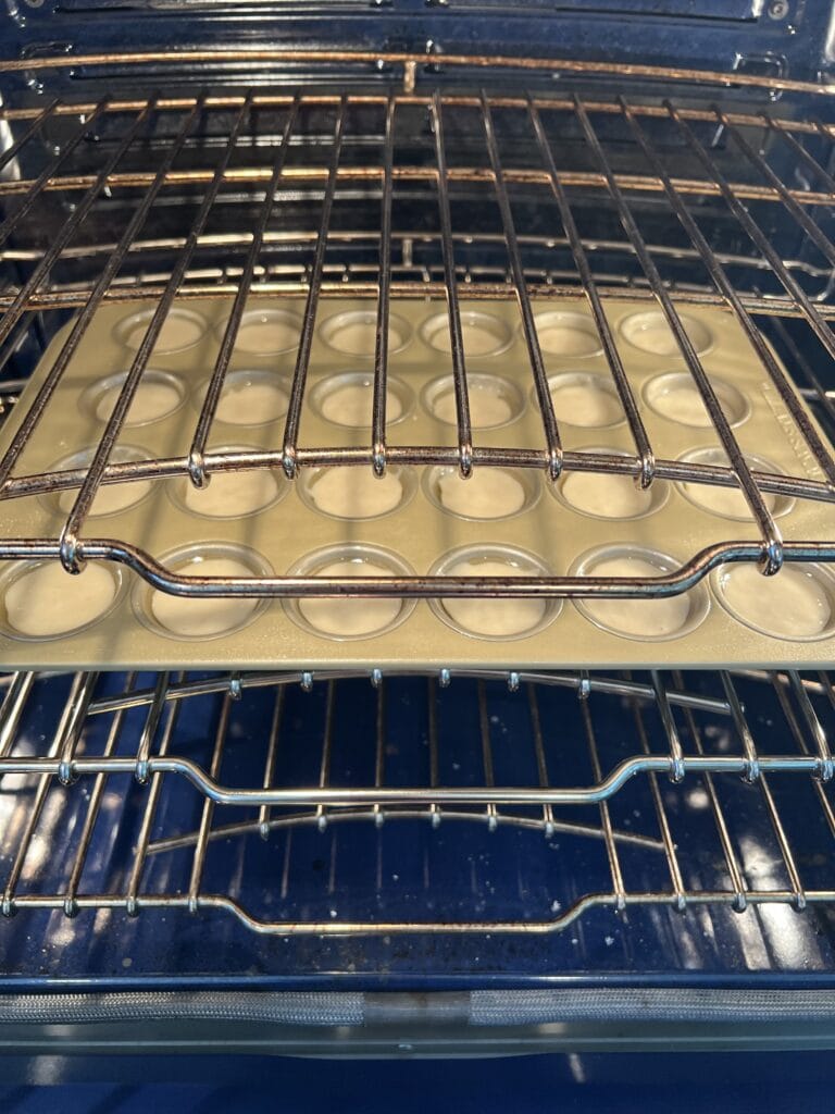 Picture of Baked Apple Cinnamon Doughnut Holes in the oven getting ready to bake. 