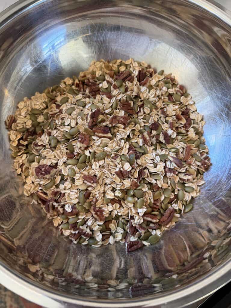 Picture of Pumpkin Spiced Granola dry ingredients in a stainless steel bowl.