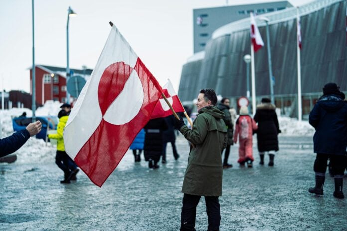 A person with the greenland flag