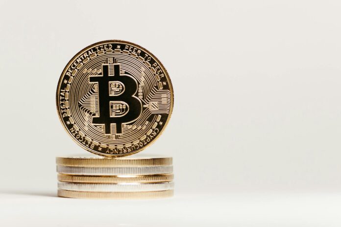 Golden Bitcoin displayed prominently on a white background showcasing cryptocurrency value.