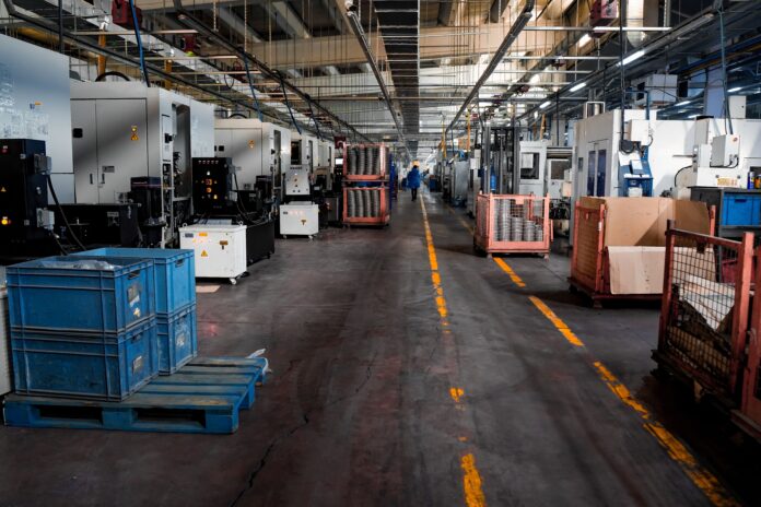 American Manufacturing Is at a Four-Year High. The Rules Change in 23 Days. At 10:00 this morning, the Institute for Supply Management released its June manufacturing data and the headline was straightforward: the US Manufacturing PMI came in at 53.3 percent, a slight miss against the 53.9 percent consensus but the sixth consecutive month of expansion, equivalent to roughly 2 percent annualised GDP growth per ISM's own historical regression. American factories are in their best sustained run since 2022. The detail beneath the headline is less comfortable. In 23 days, the tariff framework that helped produce this run expires, and what replaces it is not yet known. The Section 122 surcharge, a 10 percent flat import tariff imposed on goods from virtually all countries, took effect on February 24, 2026 following the Supreme Court's invalidation of the IEEPA tariff authority the same day. Section 122 of the Trade Act of 1974 permits the president to impose emergency tariffs of up to 15 percent for a maximum of 150 days unless Congress acts to extend the authority. The 150-day clock expires at midnight Eastern on July 24, 2026. The administration has not announced a permanent replacement. The Office of the United States Trade Representative has been conducting public hearings on proposed Section 301 country-specific tariff rates in the first weeks of July, with the objective of having new rates published before Section 122 lapses. Manufacturers have been operating, for five months, under a framework whose scheduled expiry they can see on the calendar and whose successor they cannot. That tension is visible in the ISM data, and has been since March. In the June report, ISM Chair Susan Spence noted that the Prices Index registered 73 percent, still indicating raw materials price increases for the 21st consecutive month. The June reading represented the largest single-month decline in the Prices Index since July 2022, falling 9.1 percentage points from May's 82.1 percent, driven in part by some easing in petroleum-based input costs as Brent crude has moderated below its March and April peaks. Steel and aluminium costs remain elevated on Section 232 tariffs, which were not affected by the SCOTUS ruling and are not expiring on July 24. Five of the six largest manufacturing industries reported price increases in June, per the ISM release. What the Numbers Look Like in Sequence The run of ISM data since the tariff transition in February tells a specific story. The PMI was 52.4 in February, then 52.7 in March and April, then 54.0 in May, the highest reading since May 2022. June came in at 53.3, a modest pullback but still within a narrow range that has held through six months. New orders in June registered 56 percent, down fractionally from May's 56.8 but still signalling forward demand, though panelist sentiment shifted meaningfully compared to May: 34 percent of comments were positive and 66 percent negative, a 1-to-1.9 ratio, with the Iran war cited in 31 percent of negative comments and tariffs in 17 percent. Fifty percent of panelists mentioned pricing volatility as an issue, down from 57 percent in May but still reflecting a majority of the survey base flagging price instability as an active operational concern. The one persistent weak spot is employment. The ISM Employment Index registered 49.7 percent in June, up 1.1 percentage points from May's 48.6 percent but still in contraction territory for the sixth consecutive month. That combination, rising output with contracting headcount, is the signature of a productivity-driven expansion in which manufacturers are absorbing demand with existing capacity rather than hiring. Supplier Deliveries slowed for the seventh consecutive month, registering 57.4 percent, down 3.2 percentage points from May's 60.6 percent, which reflects ongoing supply chain strain even as the pace of slowing has moderated. Business investment rose more than 10 percent in the first quarter of 2026, per the US Treasury's statement to the Treasury Borrowing Advisory Committee, driven by equipment and intellectual property expenditure. The Trump administration attributes that investment acceleration to full expensing of equipment and research and development costs, reshoring incentives embedded in the tariff structure, and deregulation. The BEA's final Q1 2026 GDP estimate, released on June 26, put annualised growth at 2.1 percent, above the 1.6 percent LSEG consensus, with information technology and professional services as the primary contributors and the AI capital expenditure cycle as the underlying engine. Deloitte's June economic forecast, published this week, projects real GDP growth of approximately 1.9 percent for both 2026 and 2027, with fixed business investment growth revised upward to 6.1 percent from a prior estimate of 4 percent on the back of AI-related capital spending. The firm also notes that much of the stimulative effect of the 2026 fiscal package has already been offset by the rise in energy costs, with the PCE price index having accelerated sharply since February before easing from its April peak but remaining well above the Federal Reserve's 2 percent target heading into summer. For households, the combination of moderating but still elevated goods inflation, energy costs above pre-war levels, and Section 232 steel and aluminium tariffs embedded in the prices of manufactured goods they buy is why consumer sentiment has not caught up with the macro data. The University of Michigan's five-year inflation expectations survey reached 3.9 percent in May, 0.6 percentage points above January, a signal that the pricing environment is becoming embedded in household expectations even as the headline rate edges lower. The July 24 Transition and What It Actually Means The replacement framework is being constructed in public, in real time, and in a compressed window. The USTR issued a Federal Register Notice in June outlining the administration's post-Section 122 intentions: a 10 to 12.5 percent Section 301 tariff on all products from approximately 60 countries subject to a forced labour investigation, with an exemption list that broadly mirrors the Section 122 exclusions currently in effect. Brazil is subject to a separate 25 percent Section 301 proposal following the conclusion of the Brazil-specific investigation. Public comment closed on the proposals in mid-June. USTR hearings are running in early July. The timeline leaves manufacturers a narrow window of certainty, as noted by the National Tooling and Machining Association, which flagged the July transition as arriving during summer shutdowns with reduced staff. The specific arithmetic matters for importers and for manufacturers dependent on imported components. A Chinese electronics manufacturer shipping to the US currently pays 10 percent Section 122 on top of 25 percent Section 301 plus applicable MFN rates. If Section 122 lapses without a Section 301 replacement, the Section 301 layer alone applies. If the new Section 301 rates are set at 25 percent for China-origin goods, the effective burden is broadly similar. For countries currently paying only the 10 percent Section 122 with no Section 301 exposure, July 25 is a meaningful inflection: Vietnam, Thailand, Cambodia, and Bangladesh face potential rates of 20 to 40 percent under the proposed Section 301 framework, substantially above the current 10 percent flat. That is the supply chain reorientation risk that does not appear in the ISM headline. The Court of International Trade ruled on May 7 that Section 122 itself was unlawfully imposed, finding that the balance-of-payments conditions cited in the proclamation did not meet the statutory standard. The ruling applies only to the plaintiffs in that case, not universally, and the administration has appealed. For the majority of importers, the surcharge remains in effect pending appellate review. What that adds to the picture is a second layer of legal uncertainty running parallel to the policy transition: manufacturers who have paid Section 122 duties since February 24 may ultimately be entitled to refunds, but only if they have filed protests and the appeal process runs in their favour. The Investment Paradox The structural paradox in the current data is that the tariff framework has been simultaneously the driver of the manufacturing expansion and the source of the price pressure that complicates it. The reshoring incentive embedded in the tariff structure has pulled forward capital expenditure, producing the business investment acceleration that the Treasury cited and the Deloitte forecast reflects. That same tariff structure has kept the ISM Prices Index in expansion for 21 consecutive months, elevated supplier delivery times for seven consecutive months, and introduced the supply chain uncertainty that 17 percent of ISM panelists cited in June alongside the 31 percent who cited the Iran war. When Section 122 transitions to Section 301 on July 25, the flat architecture changes to a country-specific one. The manufacturers who built supply chains under a 10 percent universal tariff will need to reassess costs against rates that differ by origin country. Those who reshored under the assumption of continued tariff protection will be operating in an environment shaped by a legal challenge that could unwind those tariffs retroactively. And those who planned investment cycles around the AI capital expenditure boom, which ISM's data shows is sustaining new orders at 56 percent in June, will be doing so with a Fed that is, per Minneapolis Fed President Neel Kashkari speaking at the Aspen Ideas Festival in Colorado on June 26, pencilling in one more hike before year-end and rates on hold through 2027. The gold market's positioning near all-time highs reflects a similar read on the underlying conditions: a US economy growing at 2 percent with inflation at 3.4 percent, a manufacturing sector at four-year highs but facing a known tariff cliff, and a monetary policy stance that cannot ease into the uncertainty because the inflation numbers have not yet permitted it. The conditions are not recessionary. They are not comfortable. They are the conditions of an economy that has run hard on stimulus, tariff-driven investment incentives, and AI capital spending, and that faces a structural inflection point on July 24 that most of the headline data is not yet pricing. For the energy dimension of the manufacturing cost picture, Brent crude's trajectory through July will determine how much of the June Prices Index relief holds into Q3. The ISM's Susan Spence noted in the June release that the 53.3 percent PMI corresponds historically to approximately 2 percent annualised GDP growth. The BEA's Q1 final came in at 2.1 percent. The June ISM is consistent with that range. Whether the July 24 transition interrupts it is the question that no amount of June data can answer. The hearings are running. The clock is running. The manufacturers surveyed by ISM in June were operating under a tariff structure that has 23 days left.