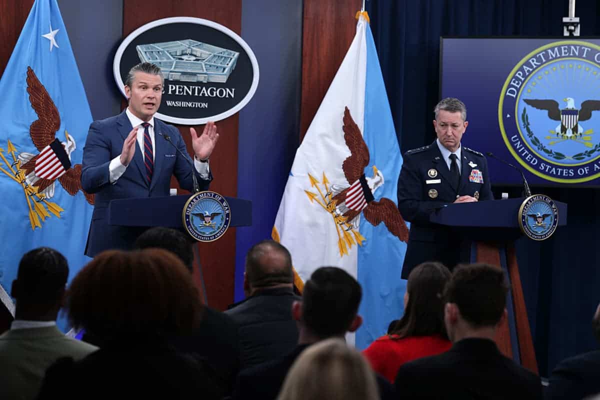 U.S. Secretary of War Pete Hegseth (L) speaks as Chairman of the Joint Chiefs of Staff General Dan Caine (R) listens during a news conference at the Pentagon on March 2, 2026 in Arlington, Virginia. Secretary Hegseth and General Caine held the news conference to give an update on Operation Epic Fury. (Photo by Alex Wong/Getty Images)