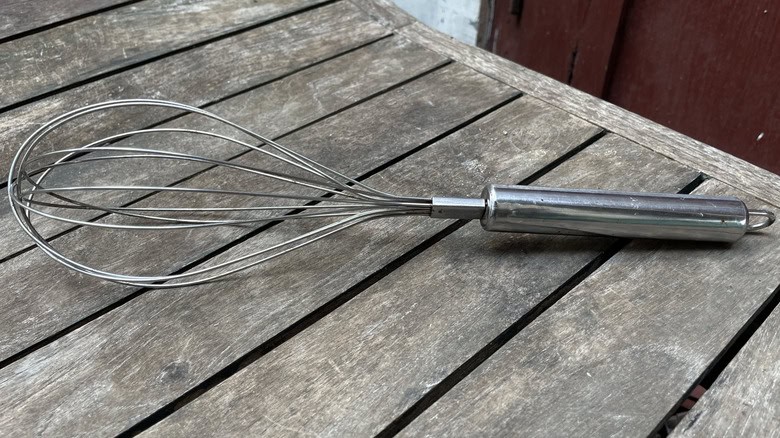Backyard dragonfly decor made from an old kitchen whisk