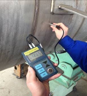 Man conducting an NDT thickness test on a pressure vessel