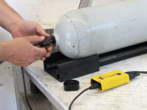 man testing scuba cylinder