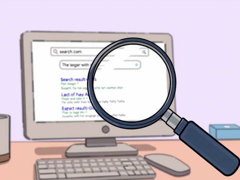 Magnifying glass over desktop search results illustrating SEO analysis and keyword research.