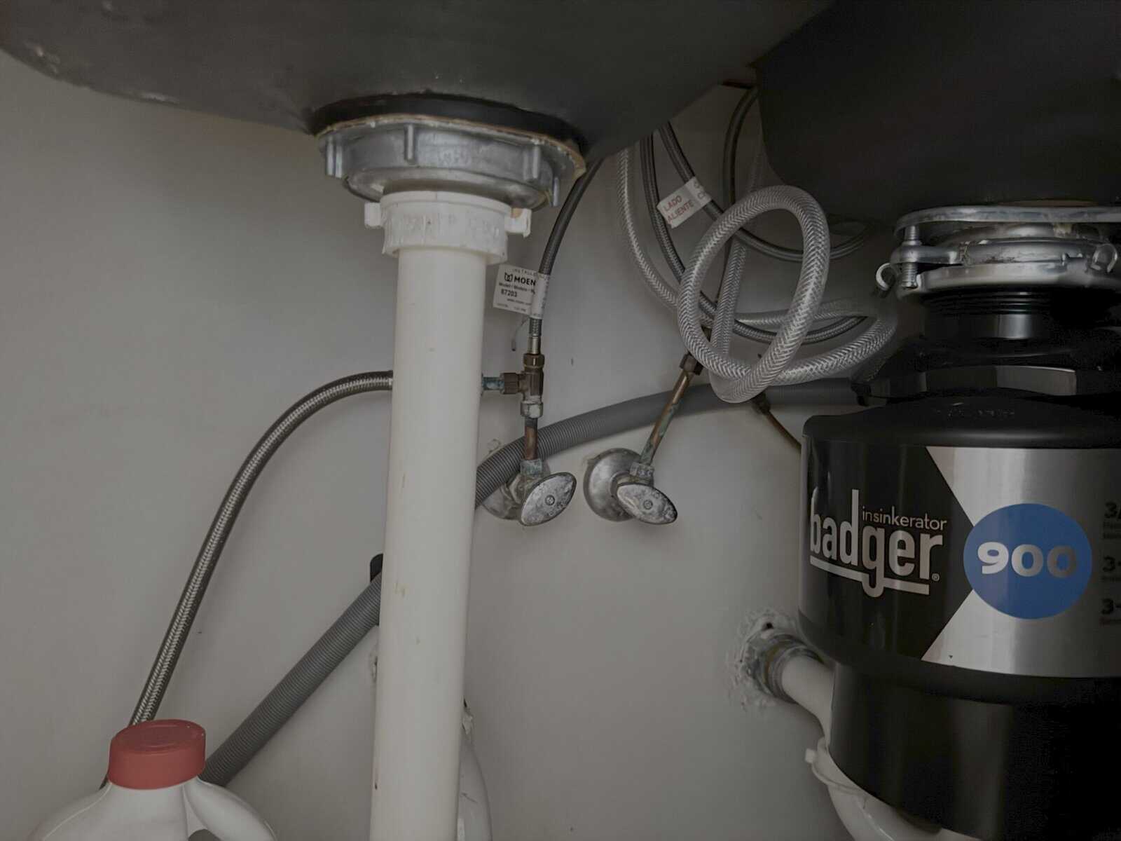 Outdated kitchen with 1970s cabinets and worn vinyl flooring