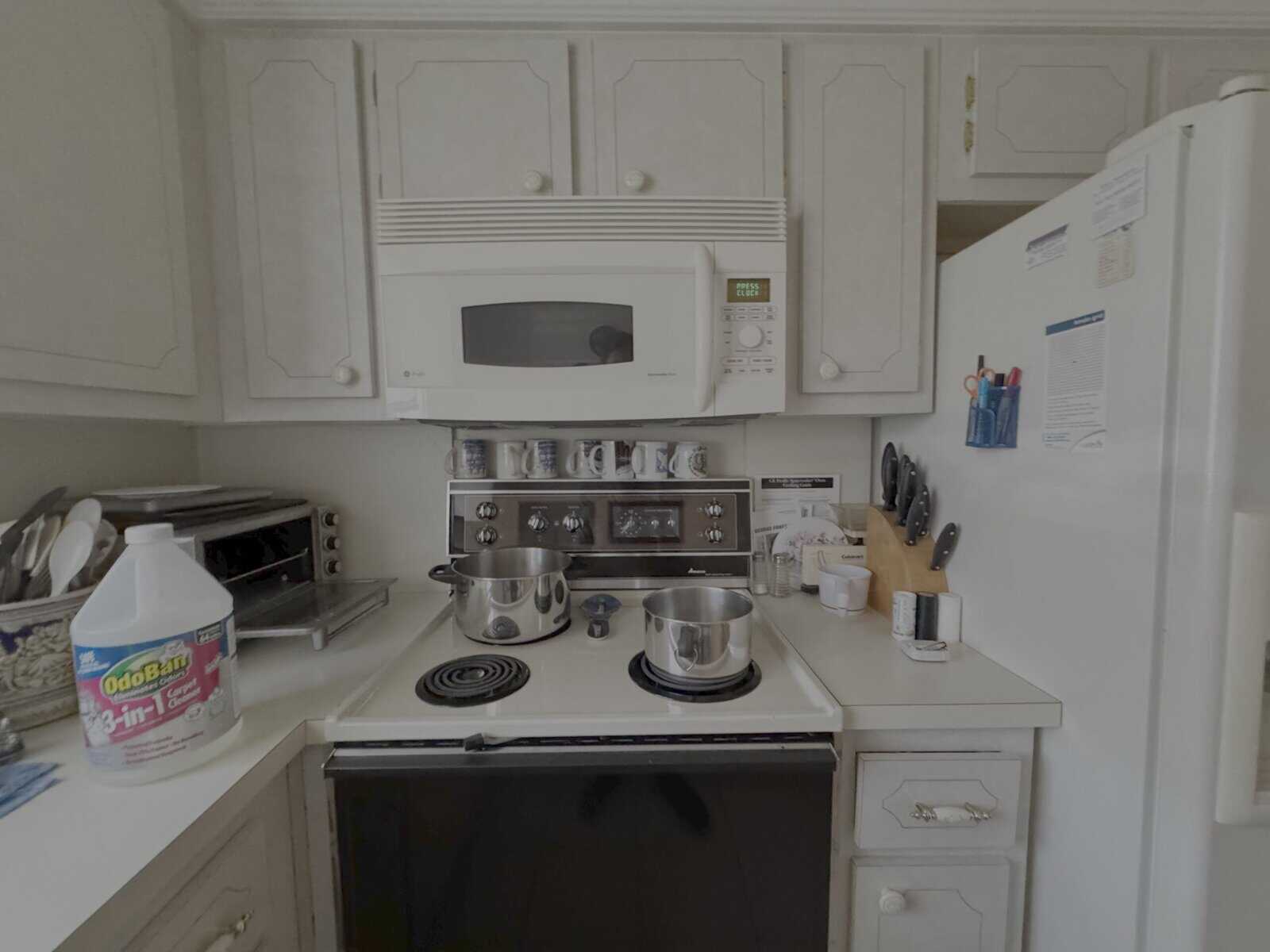 Aged stove and microwave with surface grease and discoloration