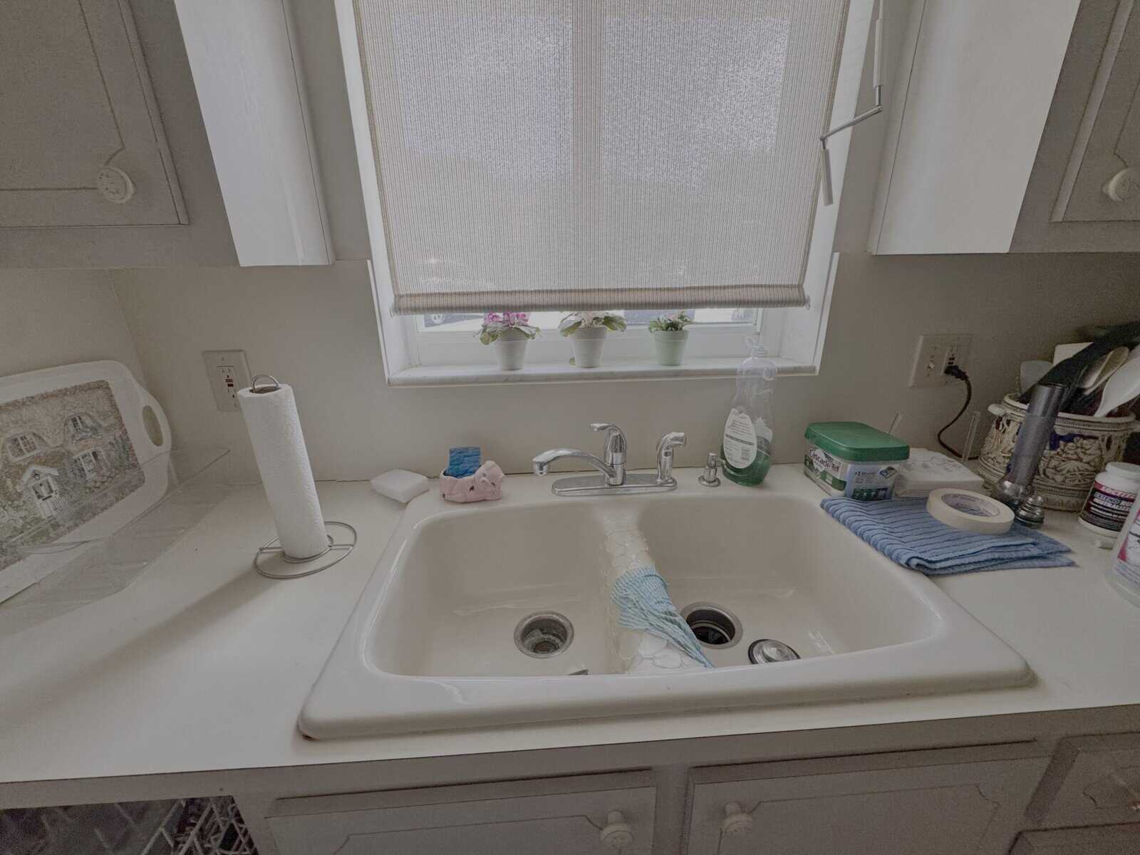Laminate countertop and sink showing staining and water damage