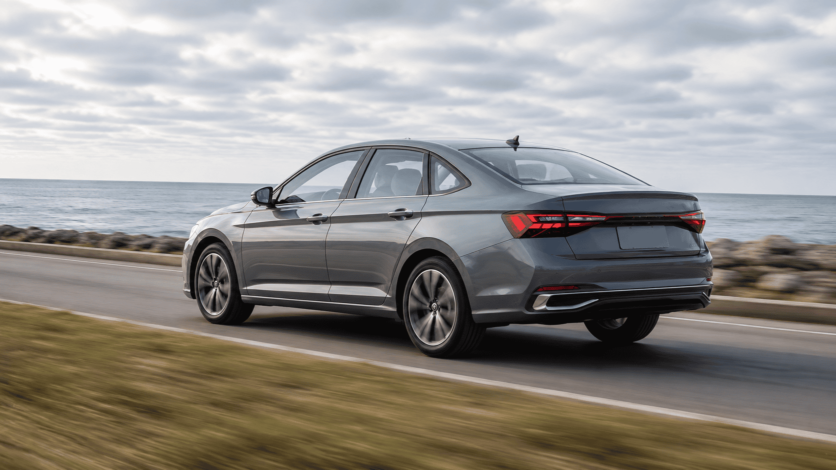 Sleek Jetta sedan cruising along the coast