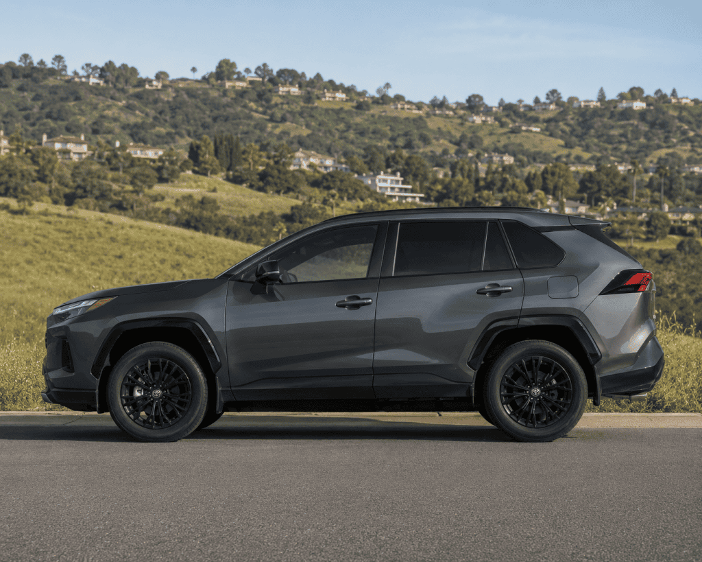 Toyota RAV 4 SUV parked with hillside setting