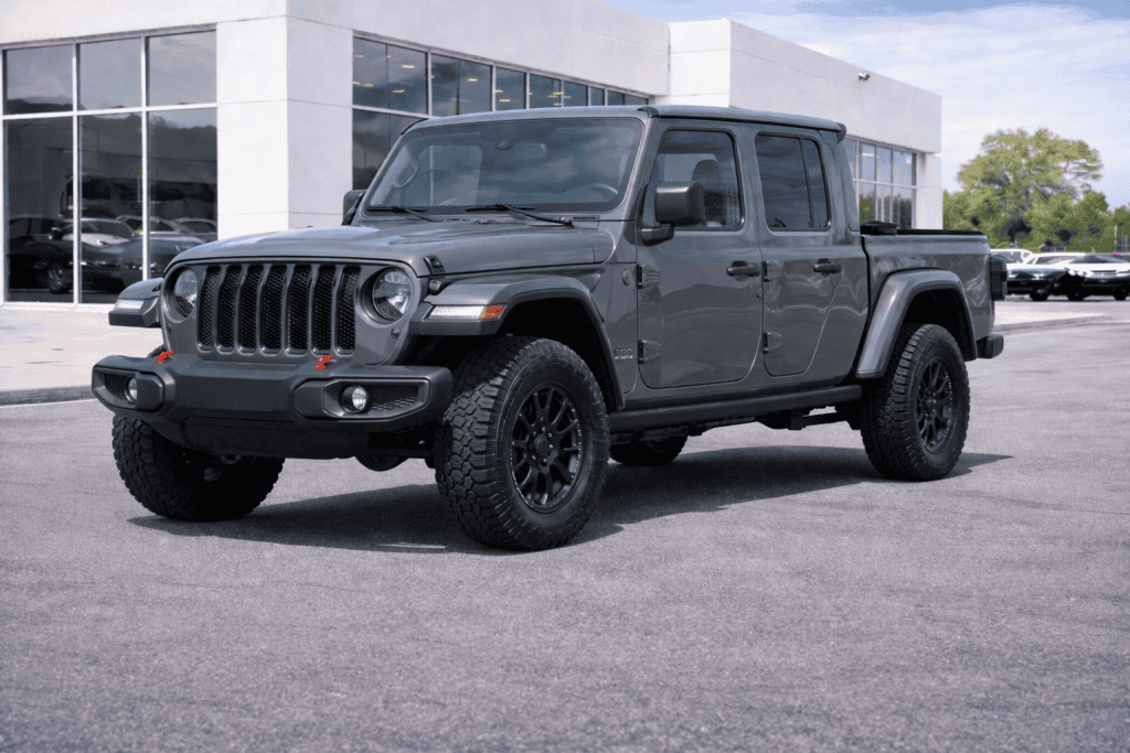 Rugged pickup at modern dealership