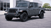 Rugged pickup at modern dealership