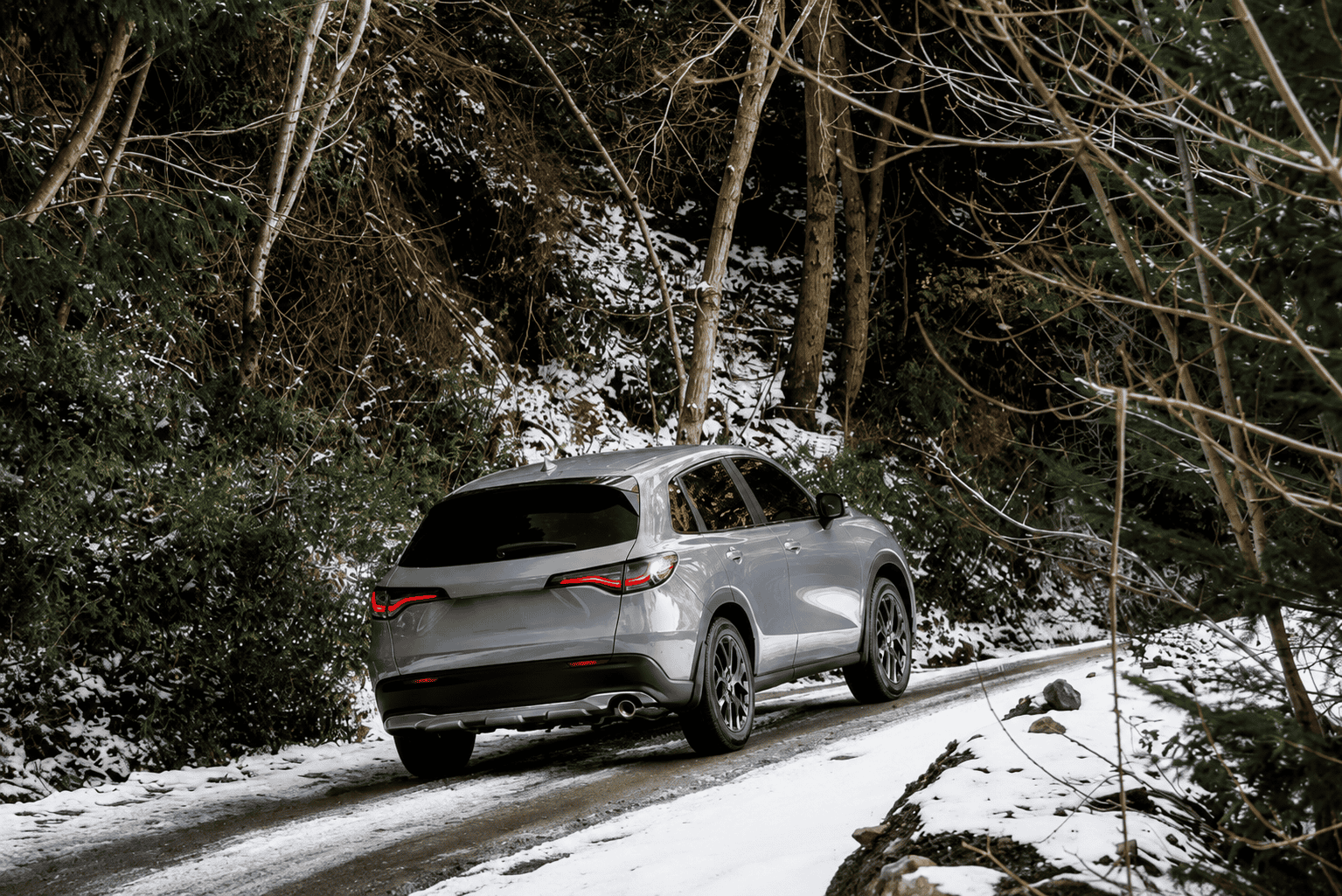 Snowy forest road with sleek Honda HR-V SUV