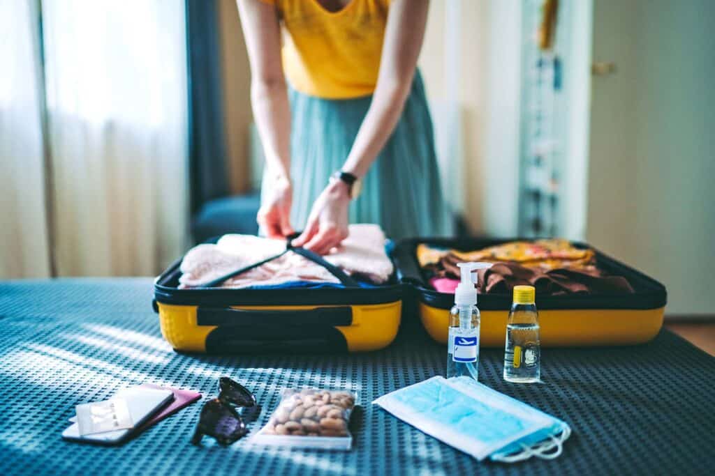 Suitcase packing for travel, COVID-19