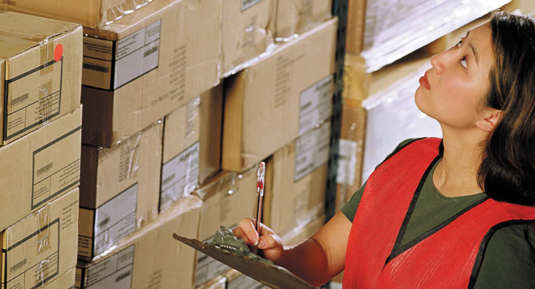 A woman with a clipboard reviewing FTZ cargo