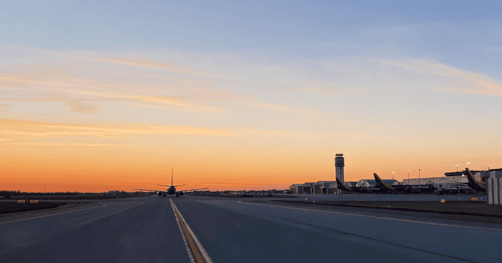 Sunset over the airfield in Columbus, Ohio, as two Southwest planes sit at their gate while another taxis to the runway.