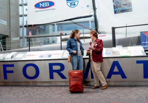 Volunteer-at-PVD-Airport A volunteer assisting a passenger at PVD airport