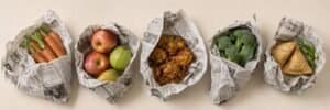 Unsafe food packaging practices involving newspapers and metallic pin