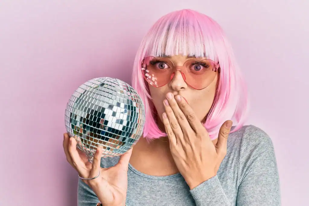 Silent disco woman with pink wig and disco ball for Mother's Day event.