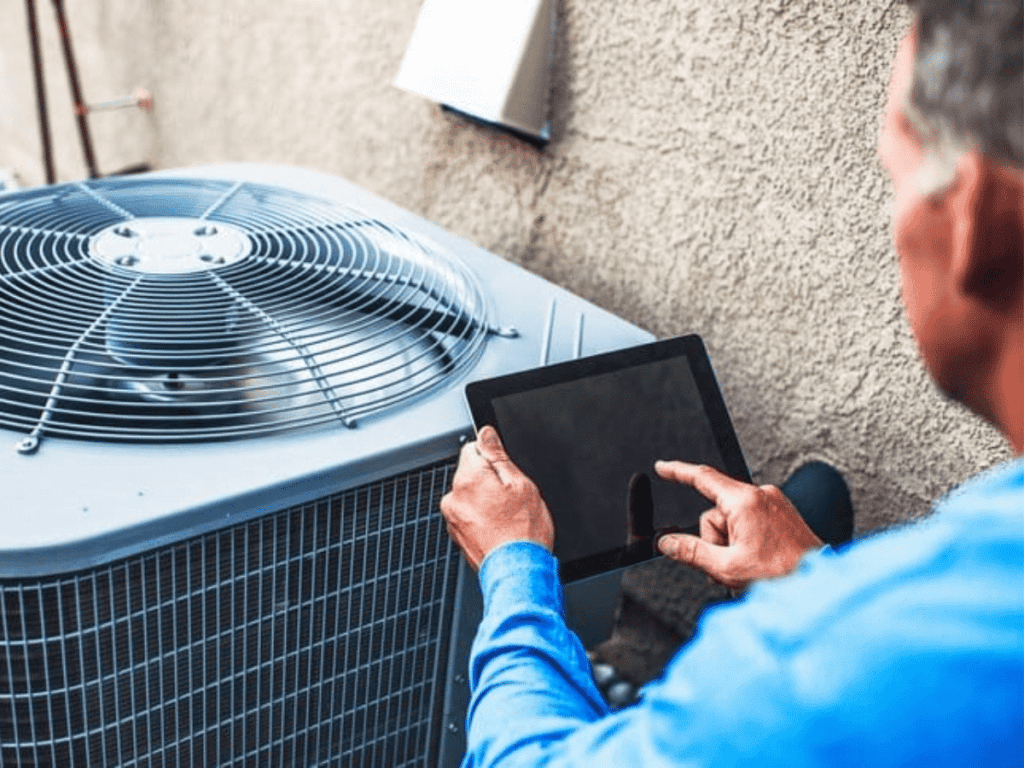 technician checking on ac unit for the summer
