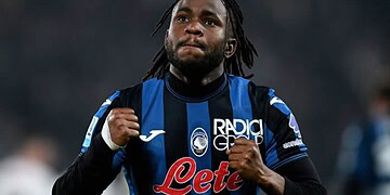 Brighton & Hove Albion football player celebrating during a match, wearing team kit with sponsor logos, on the field with a blurred stadium background.