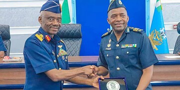 Honourable military officers shaking hands during an award ceremony at Freelanews, highlighting leadership, recognition, and military achievements in a professional setting.