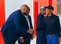 African business professionals shaking hands in a modern office setting, showcasing networking and collaboration.