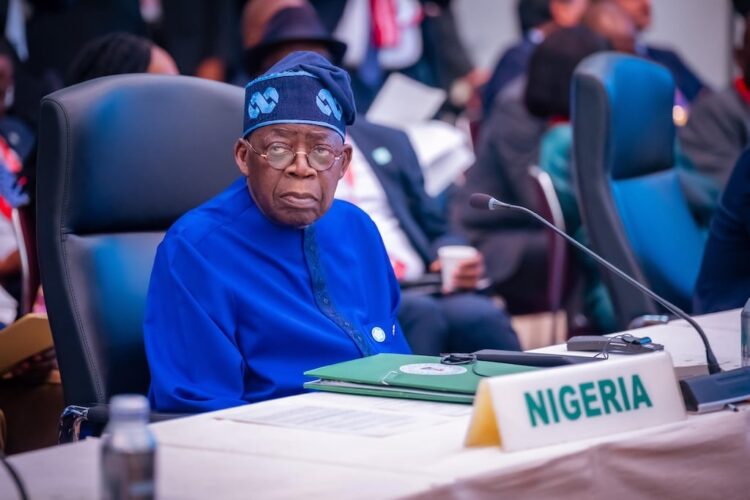 Nigerian delegate at international conference, wearing traditional blue outfit and sitting at a desk with Nigeria country label, engaged in global policy discussions about freelanews and freelance economy.