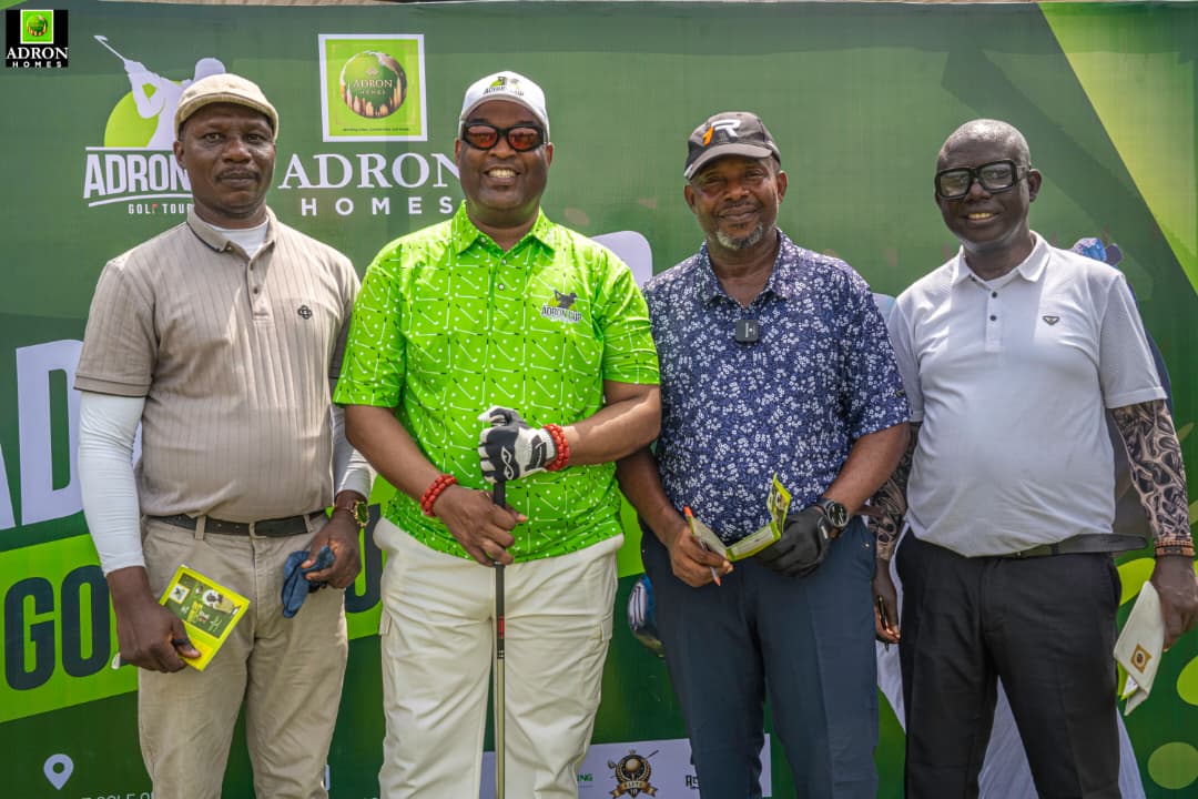 Adron Homes sponsors a charity golf event with diverse golfers on a green course in Nigeria, promoting community engagement and real estate development.